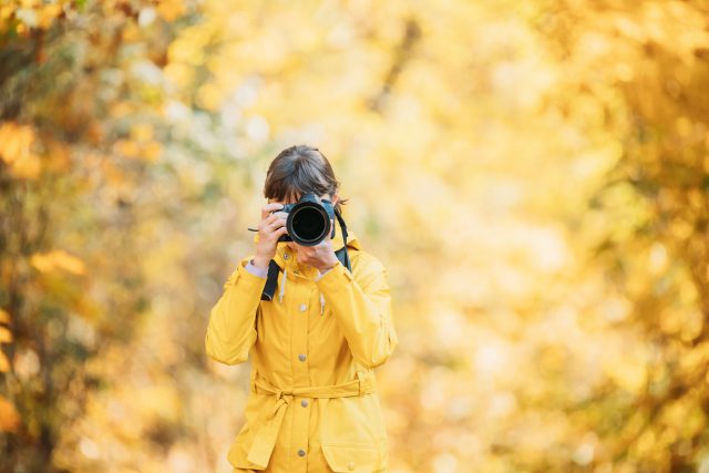 Aurlandsfjellet, Norway. Young Woman Tourist Photographer Taking