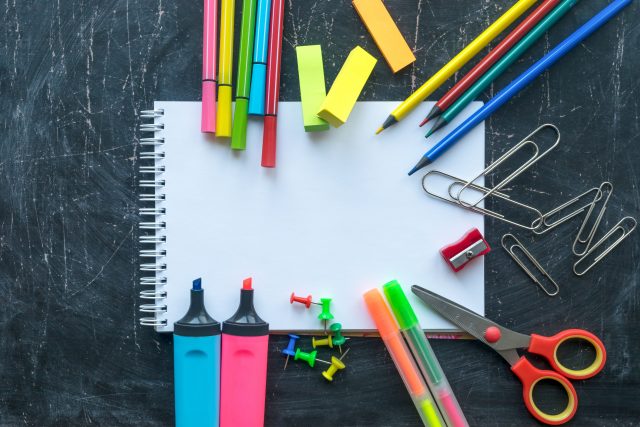 School supplies on a chalkboard background. Free space for text