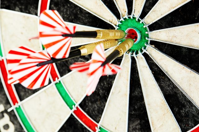 three darts in bull's eye close up. red three darts arrows in the target center business goal concept